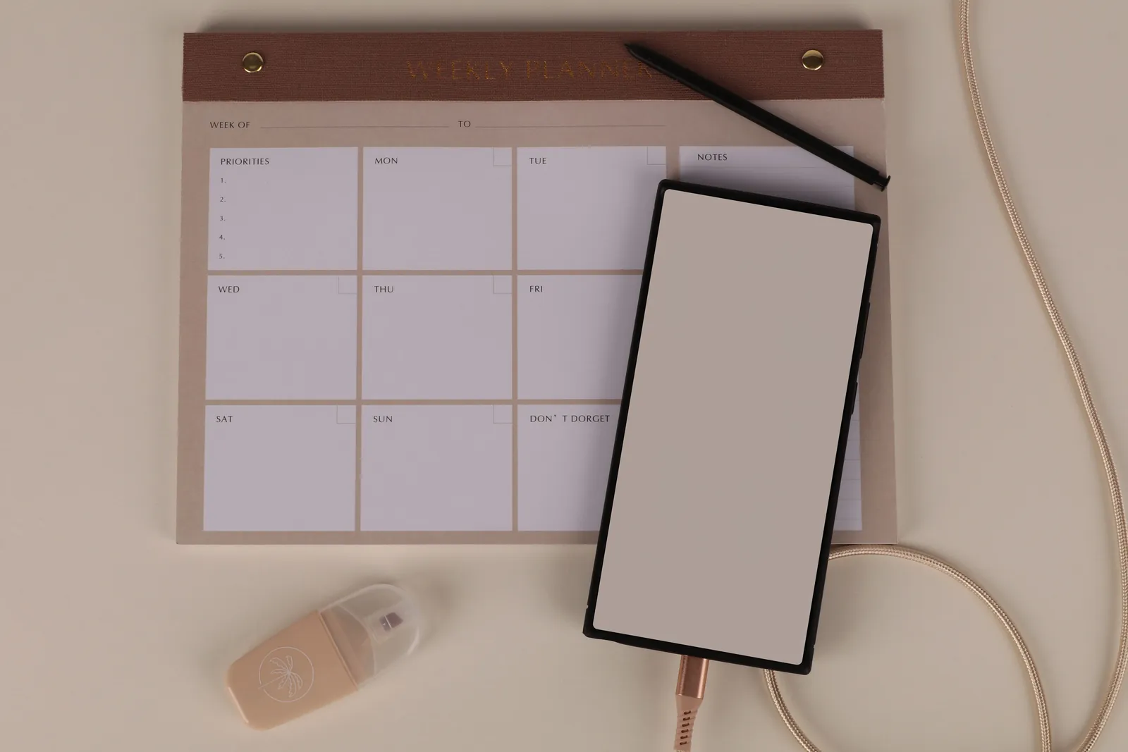 Smartphone resting on a weekly planner, ready to contact us and plan a visit