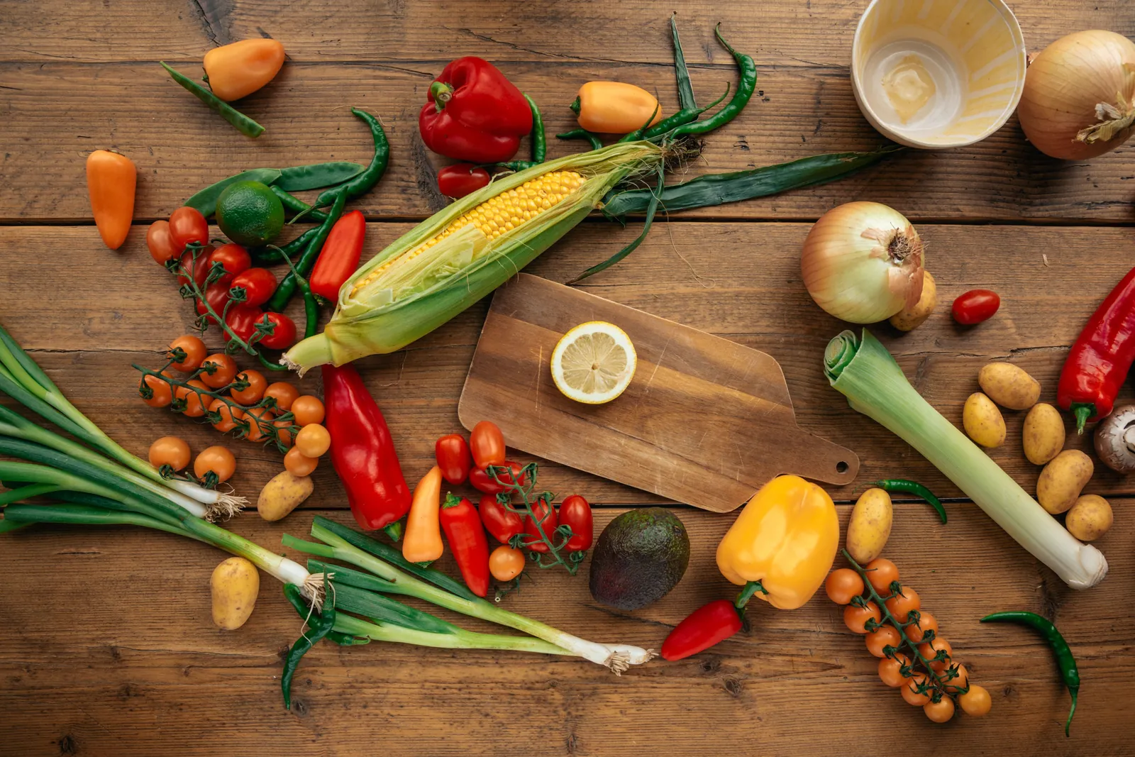 Fresh vegetables spread on a wooden table, the kind of foods discussed in nutritional counseling