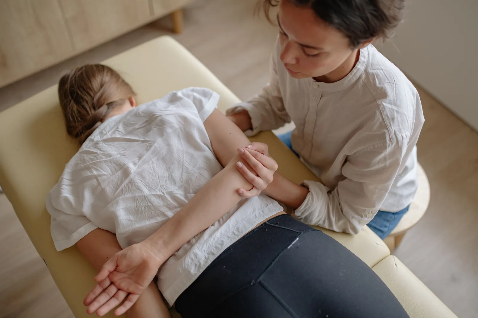 Patient lying face down on a padded treatment table during hands-on spinal care